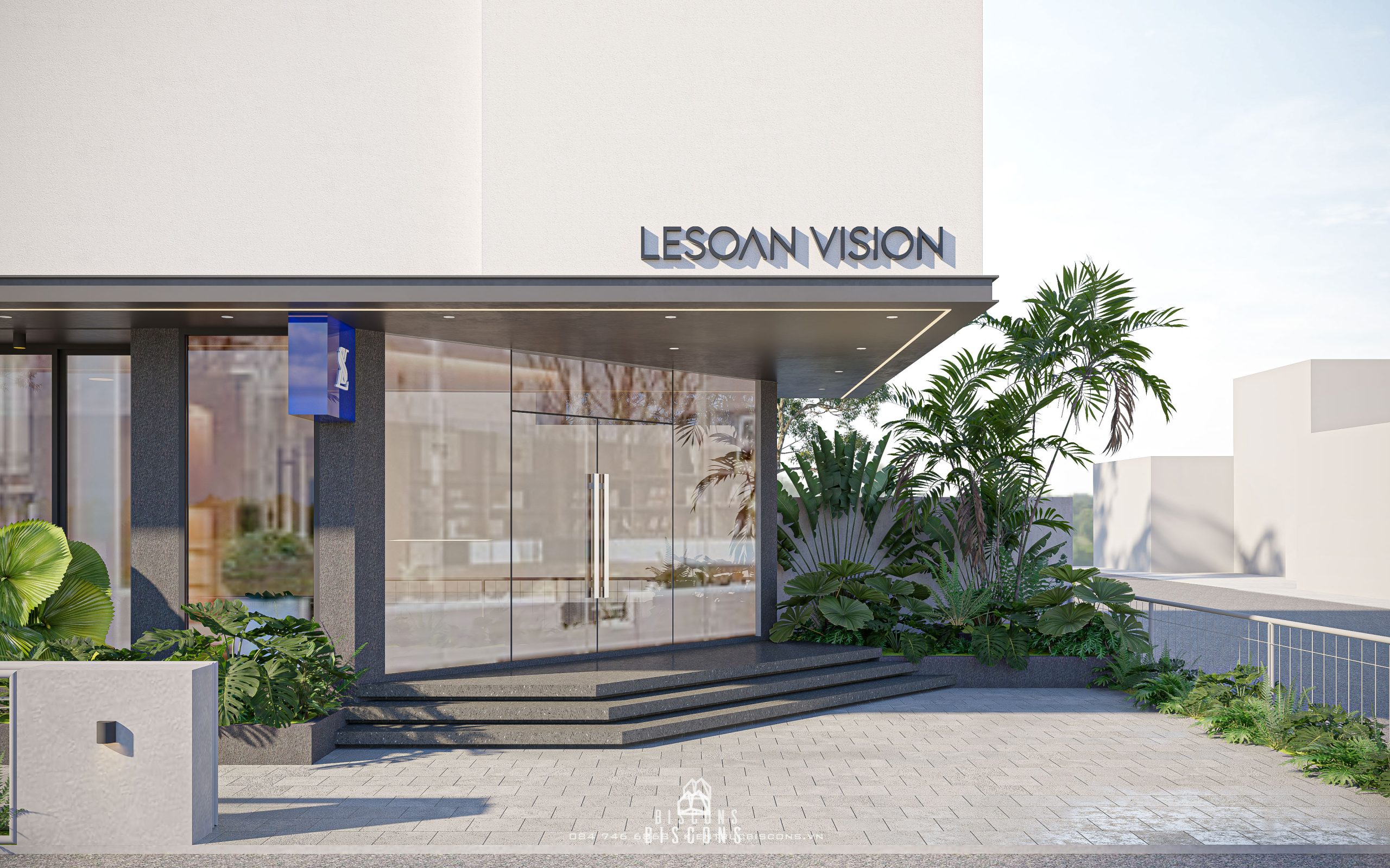Lối vào LeSoan Vision với tiểu cảnh xanh, biển hiệu chữ nổi và bậc thang đen nổi bật trên nền bê tông trắng